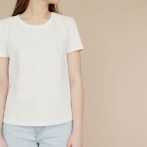 Woman wearing a white crewneck t-shirt and jeans - Ink Fervor women's tee