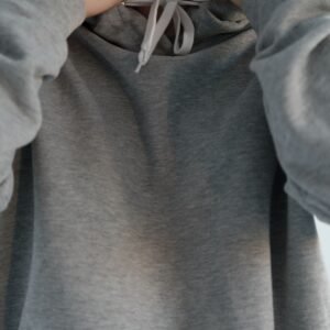 Close up of woman wearing gray hoodie - Ink Fervor sweatshirt fabric detail